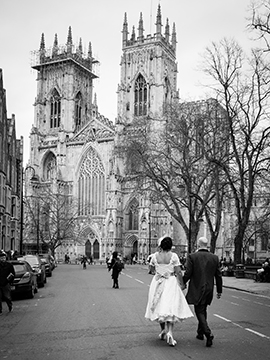 Bride and groom walk towards York Minster www.oliviabrabbs.co.uk