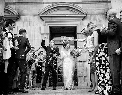 leeds wedding photography bride and groom leaving civic hall with confetti