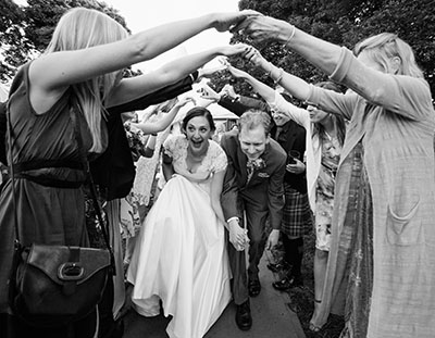 documentary wedding photography of bride and groom leaving marquee